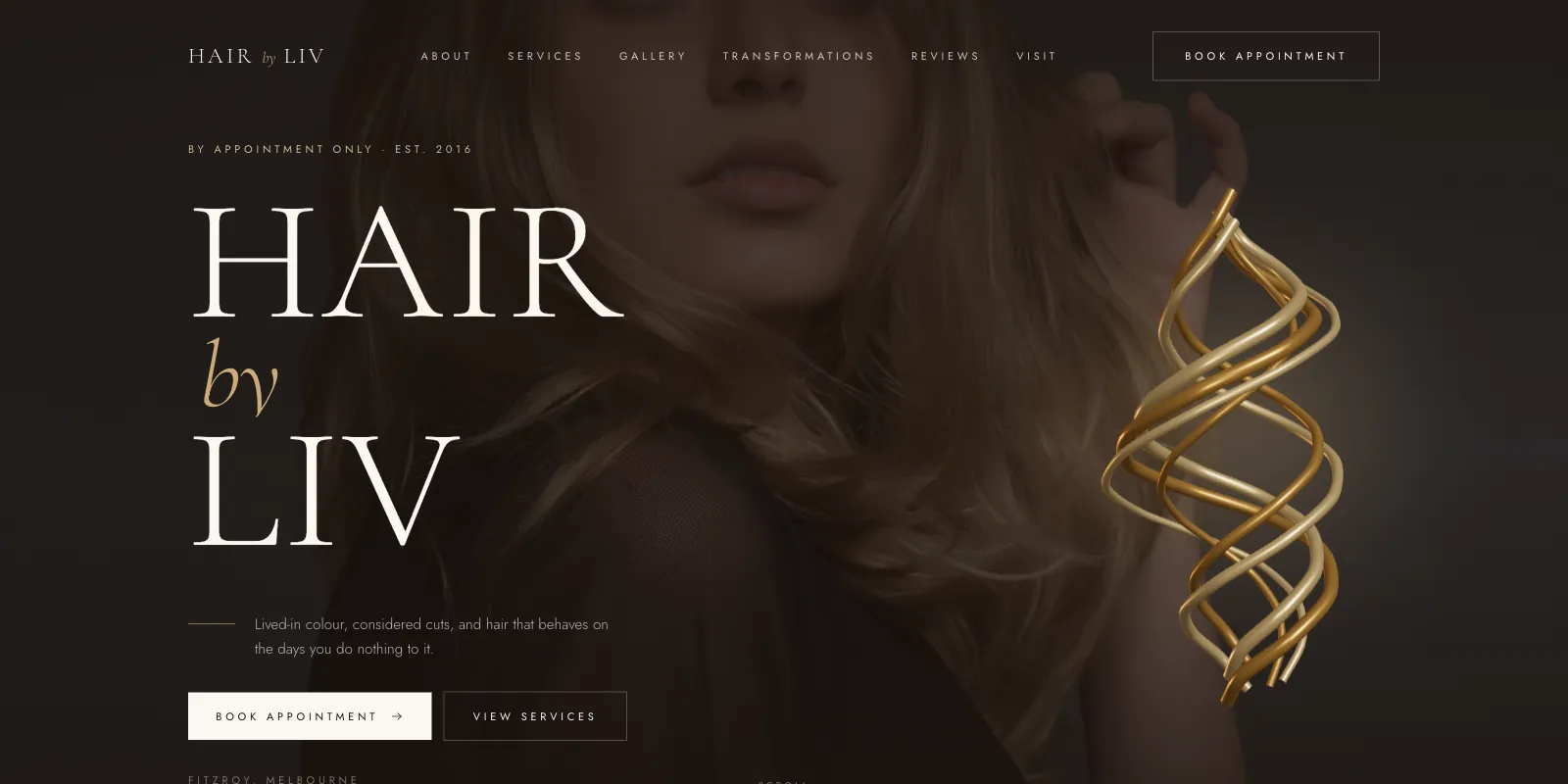 Hair by Liv home page — an editorial serif wordmark beside a gold 3D spiral